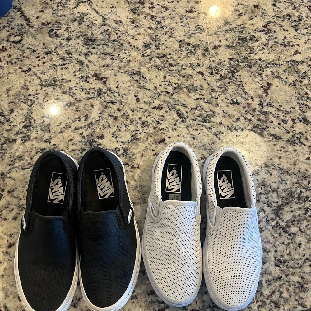 White and black pair of Vans. They are more of a wipeable material (not canvas.